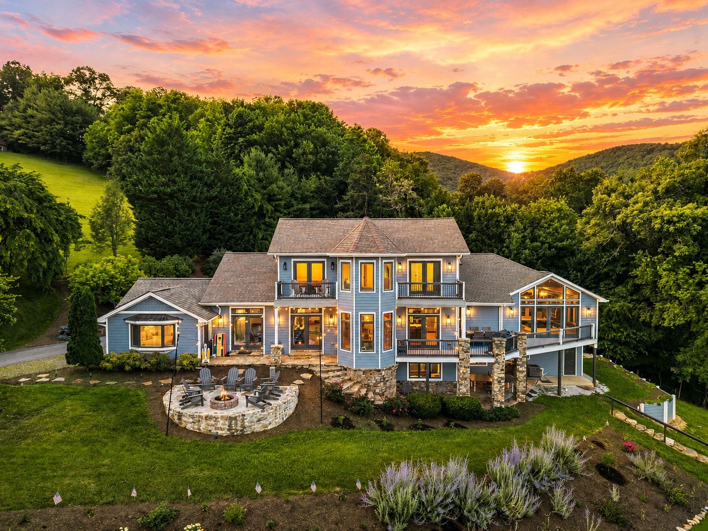 A large, two-story house with a stone foundation, multiple windows, and a well-maintained lawn.