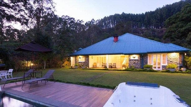 A house with a pool, outdoor furniture, and a hot tub.
