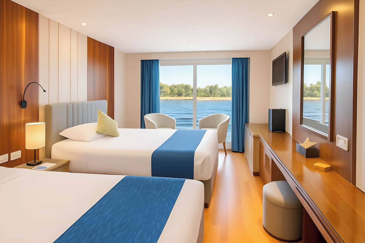 A hotel room with two beds, a desk, a TV, and a large window with a view of the water.