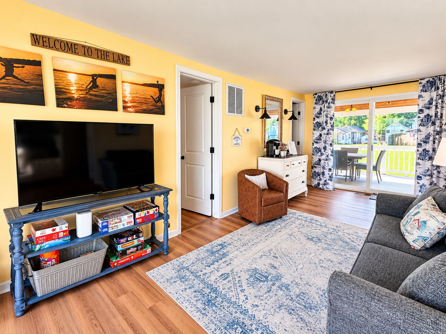 A living room with a TV, a coffee table, a sofa, and a rug.