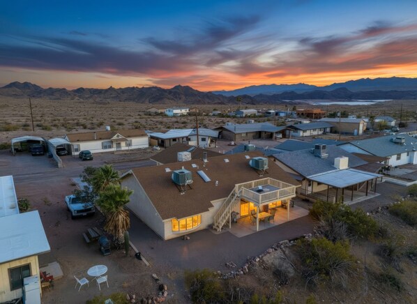 A residential area with houses, a parking lot, and a view of mountains.