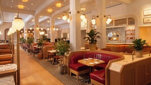 A restaurant with booths, tables, and a bar area.