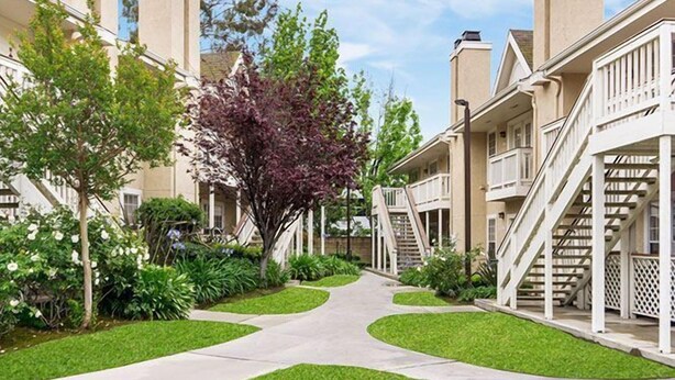 A residential building with a central pathway, surrounded by greenery and trees. - 2 Units: 1BR Suite w/ Full Kitchen & Outdoor Pool | 2.8 Mi to Nixon Library (Brea)