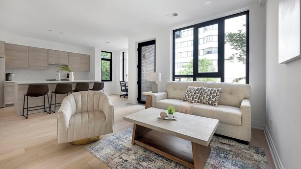 A modern apartment with a kitchen, dining area, and living room. - Landing | Incredible 2BD in Logan Circle (Washington)