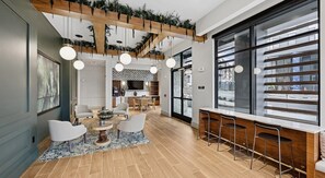 A modern interior with a dining area, bar, and kitchen. - Landing | Stunning 1BD, Gym, Courtyard (Nashville)