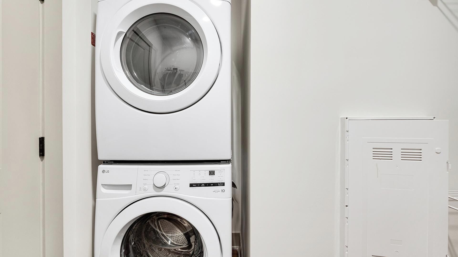 Une machine à laver et un sèche-linge superposés dans une buanderie.