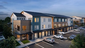 A multi-story residential building with a parking lot. - Landing | Incredible 1BD, Clubhouse (Austin)