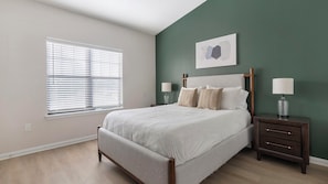 A bedroom with a bed, bedside tables, a window with blinds, and a wall-mounted artwork. - Landing | Amazing 2BD, Gym (Garland)
