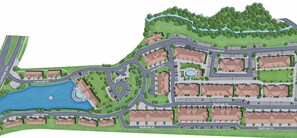 Zona residencial con varios edificios, calles y una fuente central.