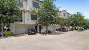 A residential street with two-story houses, parked cars, and trees. - Landing | Spectacular 2BD, Gym (Garland)