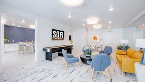 A modern lobby with a pool table, seating area, and a reception desk. - Landing | Stunning 1BD, Gym, Pool (Austin)