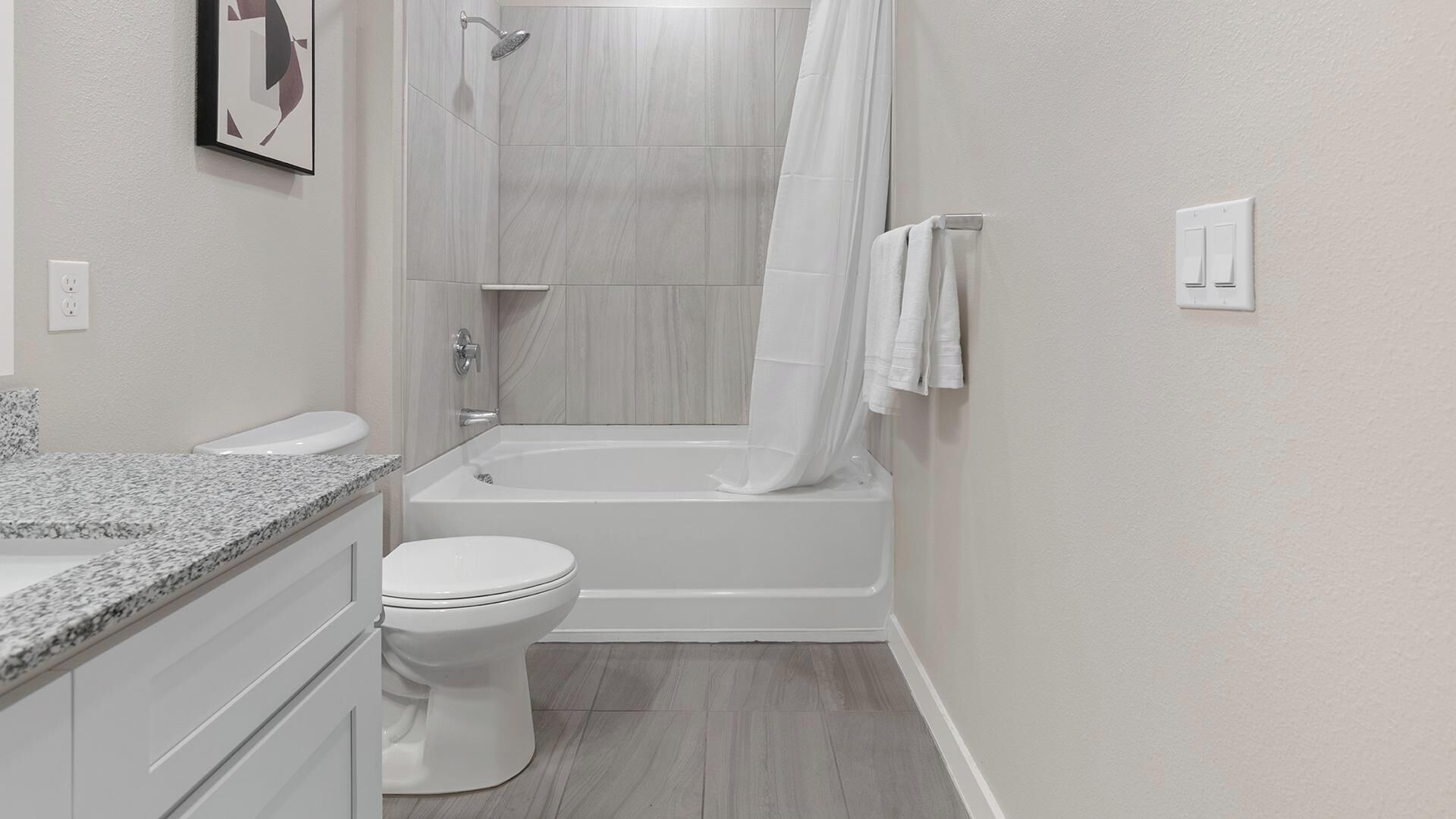 A bathroom with a toilet, a shower, and a bathtub.