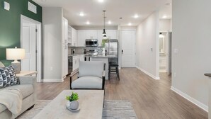 Una sala de estar moderna con un sofá, una mesa de centro y un comedor con una silla y una mesa.