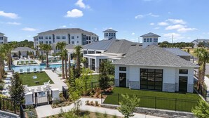 A residential area with modern houses, a swimming pool, and well-maintained lawns. - Landing | Spectacular 1BD, Yoga Studio, Gym (Four Corners)