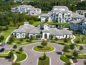 A residential area with modern houses, a roundabout, and a parking lot.