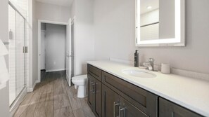 Ein modernes Badezimmer mit Toilette, Waschbecken und Spiegel.