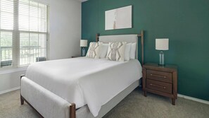 A bedroom with a bed, two bedside tables, a window, and a wall-mounted artwork. - Landing | Incredible 2BD in Copperfield (Cypress)