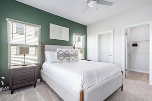 A bedroom with a bed, nightstands, a ceiling fan, and a door leading to a closet. - Landing | Beautiful 1BD, Clubhouse, Gym (Santa Rosa)