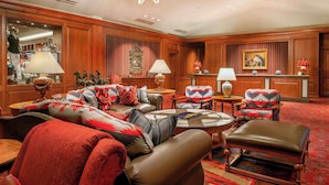 A spacious lobby with leather sofas, patterned armchairs, and a chandelier. - Little America | 2 Queens Pool | Quiet Privacy, Resort Campus | 2 Units (Cheyenne)