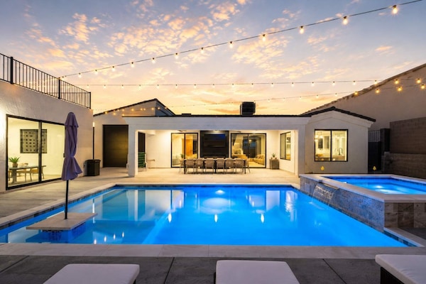 Desert Palm at sunset, with a luminous pool, open courtyard, and warm desert skies setting the tone for an unhurried Havasu stay.