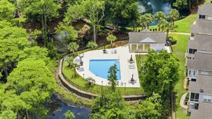 A residential area with a swimming pool, a gazebo, and a view of a lake. - 4BR NMB Ocean Drive Cottage, quiet community and walk to everything you need! (North Myrtle Beach)