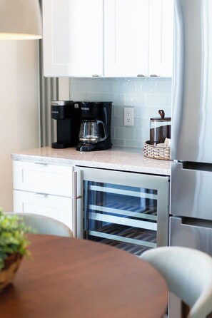 A kitchen with a coffee maker, a toaster, and a refrigerator. - Modern Loft in the Rosemary District-DT Sarasota 2 (Sarasota)