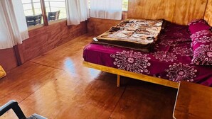 A room with a bed, a chair, and a window. - Adventure trails (Kodaikanal)