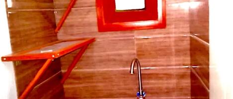 A bathroom with a wooden vanity, a sink, and a mirror.