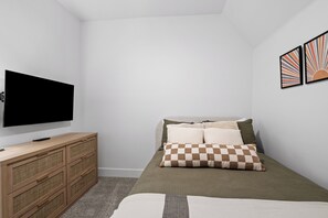 A bedroom with a bed, a television, a wooden dresser, and two wall-mounted artworks. - Brand new townhome in Depoe Bay!  Gorgeous views and neighborhood! (Depoe Bay)