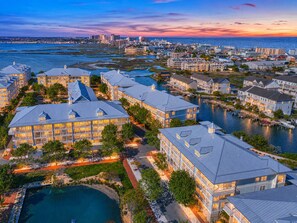 A coastal resort with multiple buildings, a marina, and a large body of water. - 3BR Resort Condo with Pools by Beach (Ocean City)