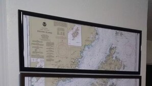 Two framed maps on a wall. - The Kodiak Cabin w/ King Bed (Seward)