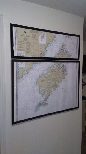Two framed maps on a wall.