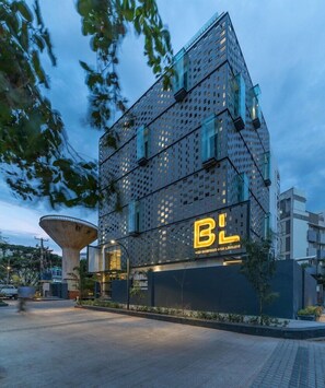 A modern building with a prominent 'BL' sign, featuring a unique perforated facade and a large, cylindrical structure nearby. - Hotel BL (Hyderabad)