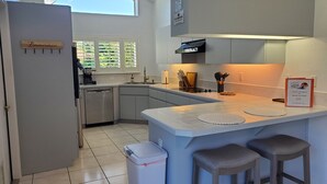 A modern kitchen with a built-in island, bar stools, a dishwasher, and a sign indicating a smoking-free area. - Dreamin O'Sprey! Amazing View & Plenty O'Privacy! (Clermont)