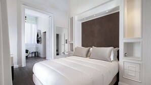 A modern bedroom with a large bed, built-in shelving, and a walk-in closet. - Terrazza Di Sorrento, Town Centre Apartment (Sorrento)