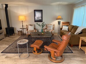 A living room with a fireplace, two armchairs, a sofa, a coffee table, and a rug. - Herbert Hideaway | Shared Pool & Hot Tub (South Lake Tahoe)