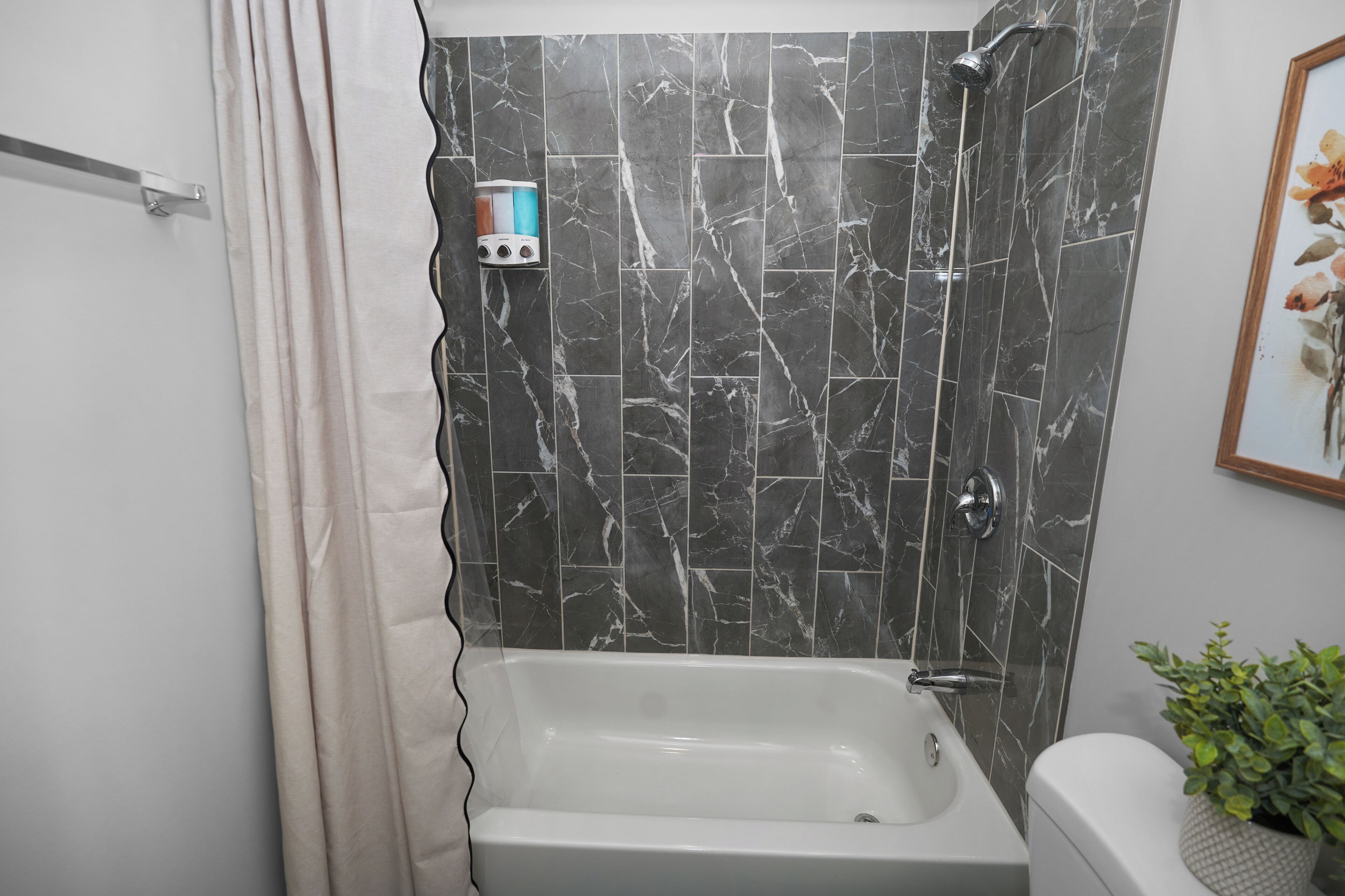 A bathroom with a bathtub, a shower, and a toilet.