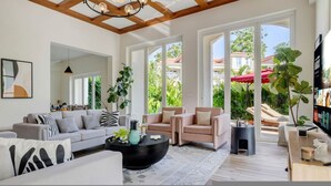 A spacious living room with a modern design, featuring a large sofa, a coffee table, and a fireplace. - Villa Sai Shukhrana 3bhk w Private Pool in Moira (Moira)