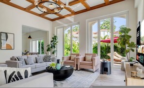 A spacious living room with a modern design, featuring a large sofa, a coffee table, and a fireplace.