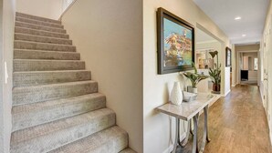 A staircase leading to a landing with a framed picture above. - Las Vegas Quiet Compound (Las Vegas)
