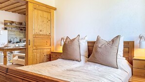 A wooden bed with a headboard, bedside tables, and a nightstand.