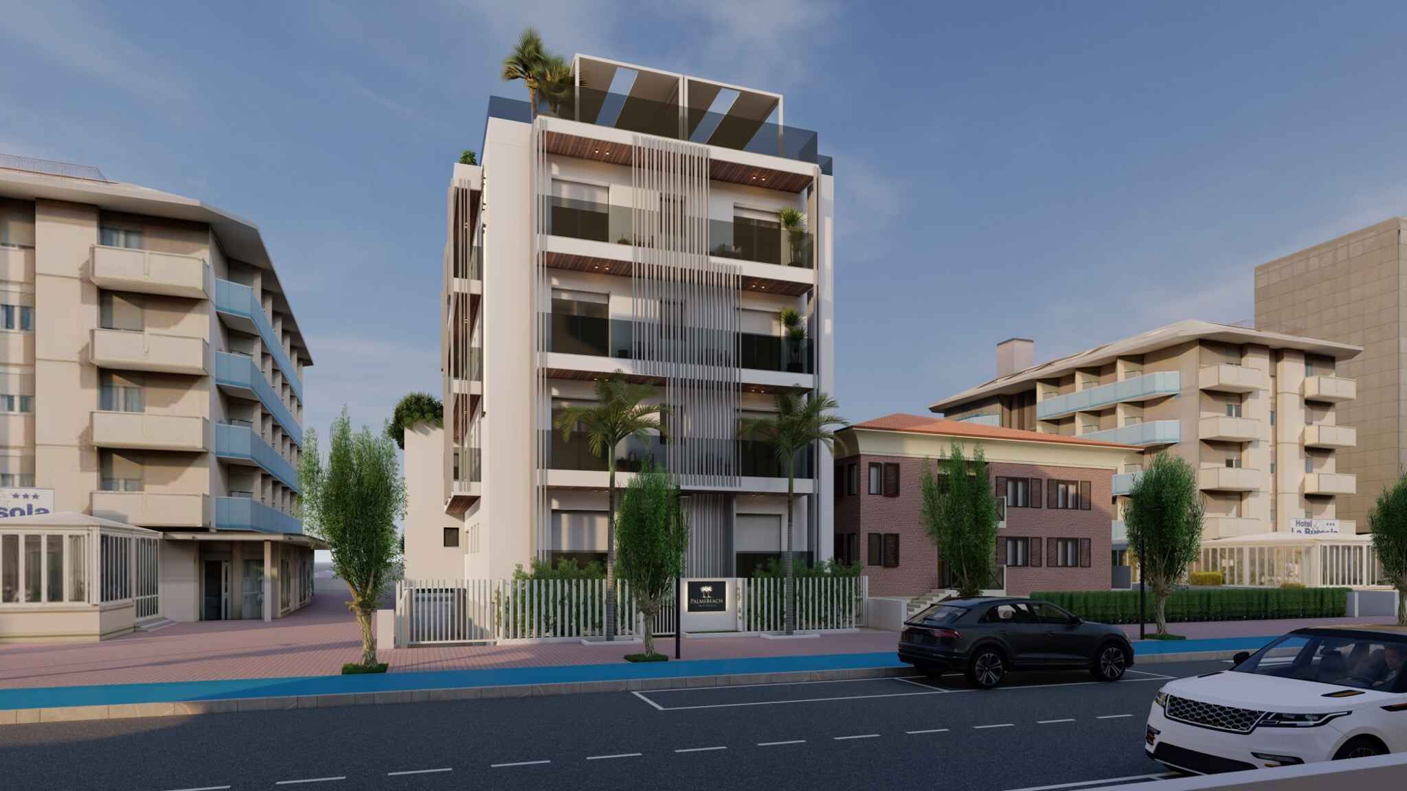 Un hotel moderno de varios pisos con un atrio central, balcones y un área de estacionamiento.