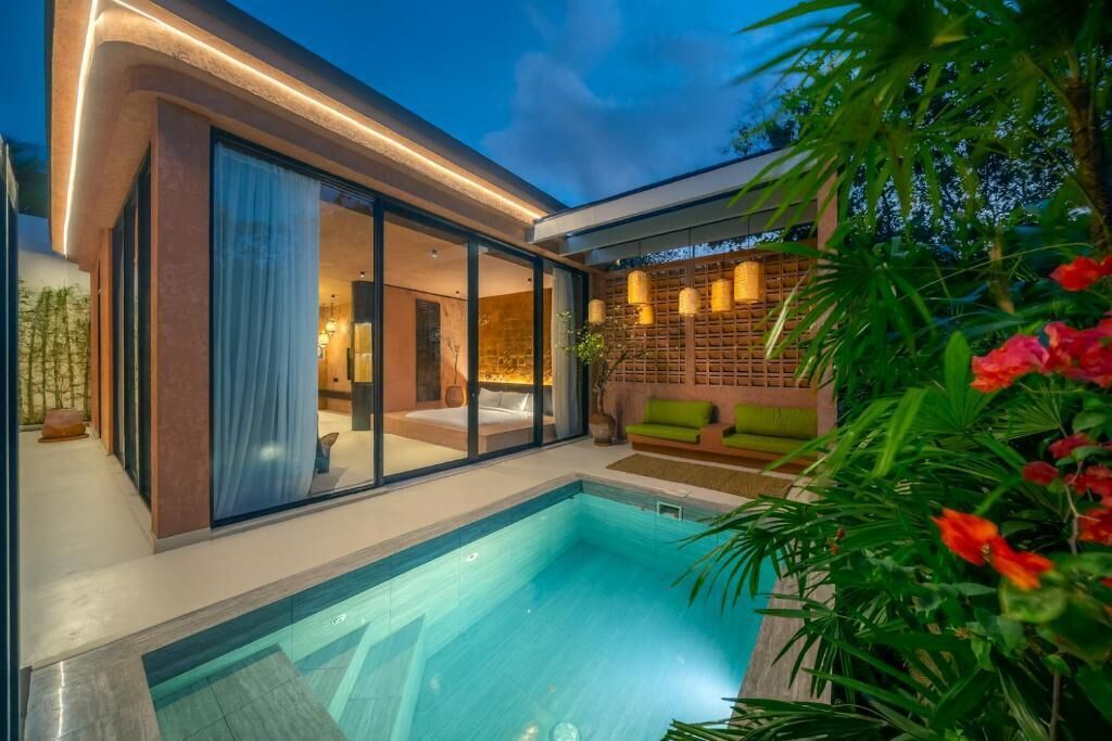 A modern house with a swimming pool, large glass doors, and a cozy interior.