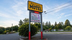 A motel sign with amenities including free 7G internet, military discount, and a contact number.