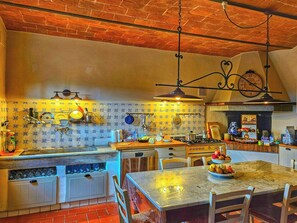 A kitchen with a brick ceiling, tiled backsplash, and a marble countertop. - Hidden villa among olive trees in Tuscany (Palaia)