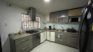A kitchen with a stove, oven, microwave, and refrigerator.