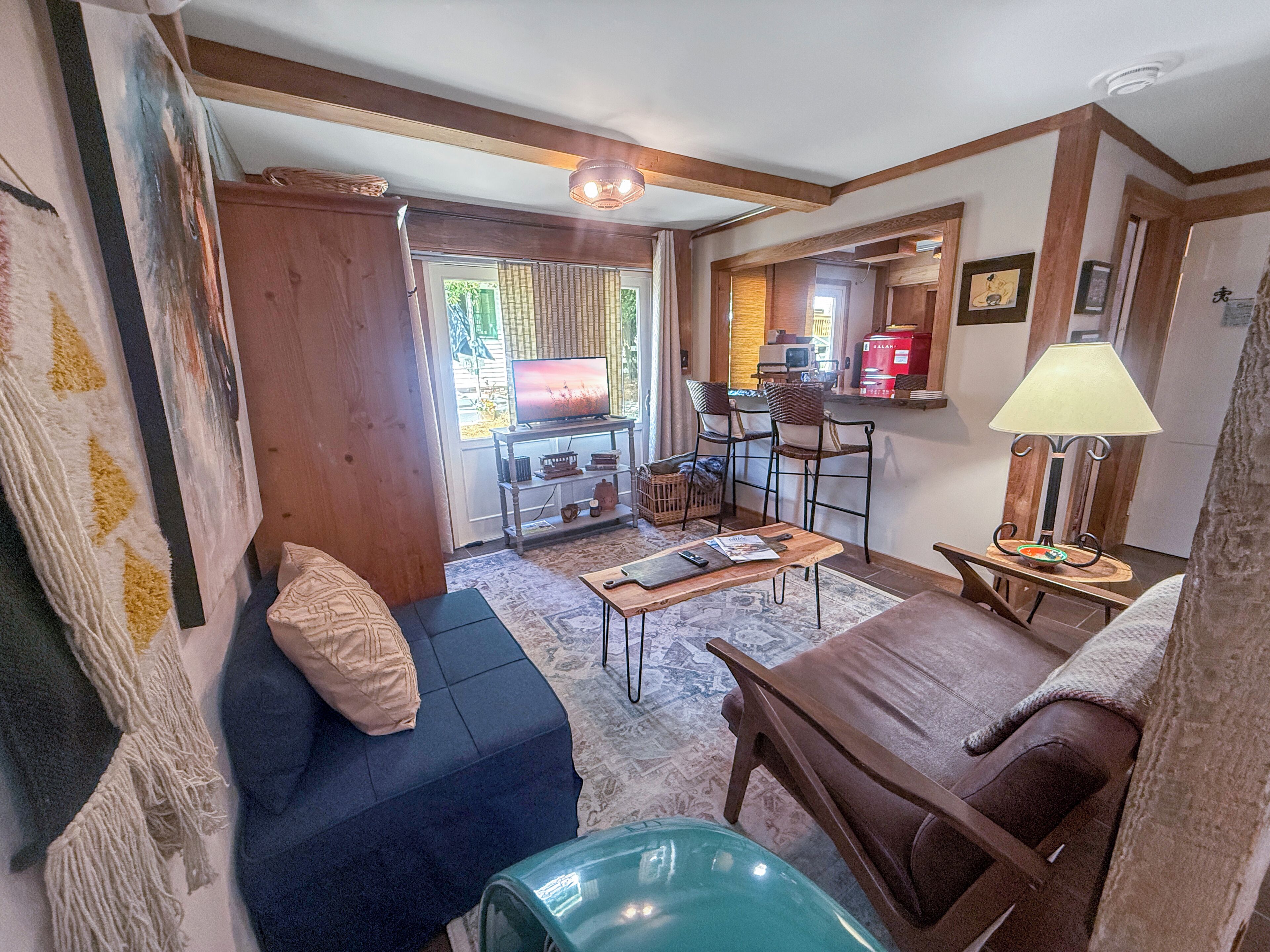 Cozy cabin-style living room with bar seating and warm wood accents. Twin futon 