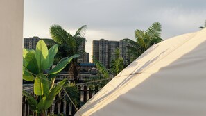A tent-like structure with a view of a cityscape in the background. - Parkside Inn (Beijing)