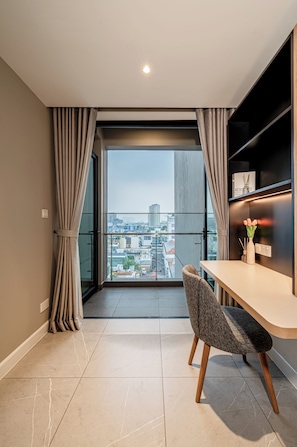 A modern room with a balcony, a dining table, and a chair. - Zenity & D1 Mension Apartment by NIDOVA (Ho Chi Minh City)