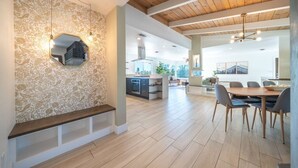 A modern interior with a dining area, kitchen, and living space.